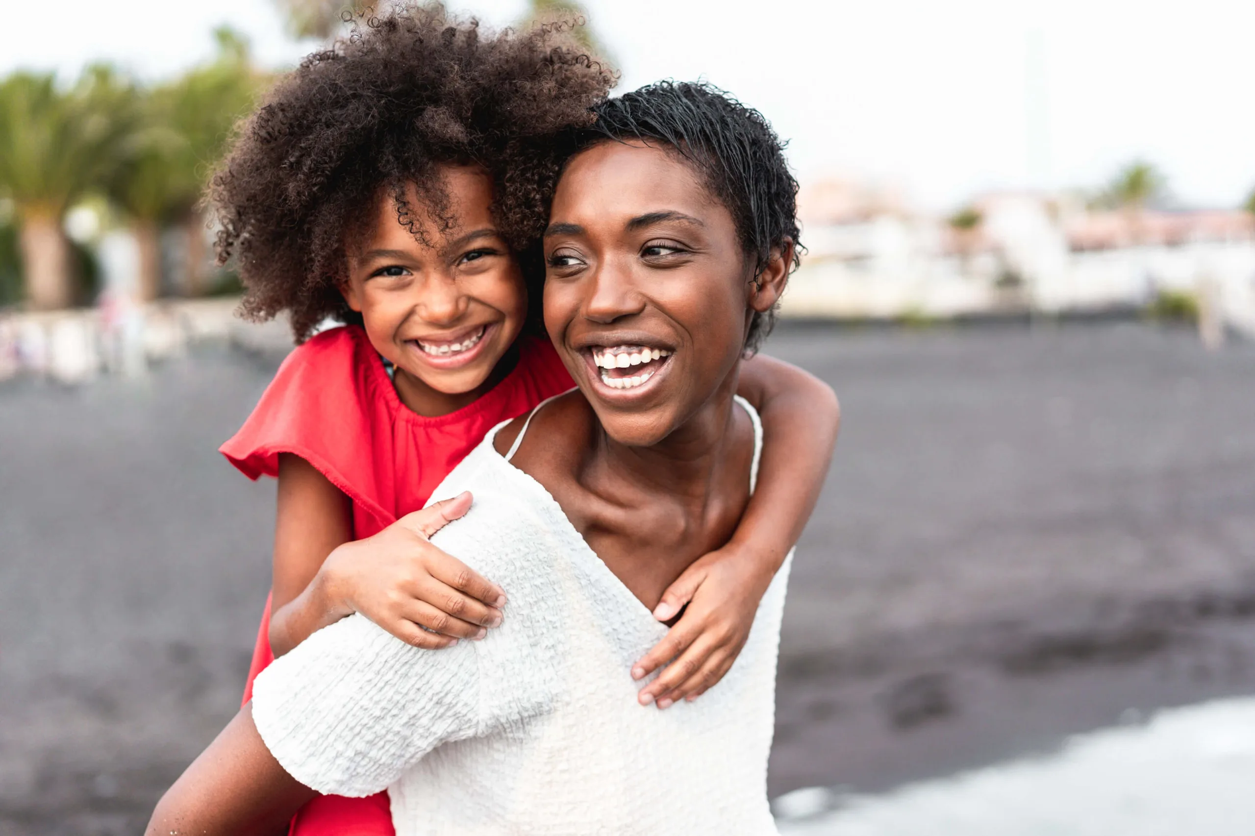 african-mother-daughter-having-fun-beach